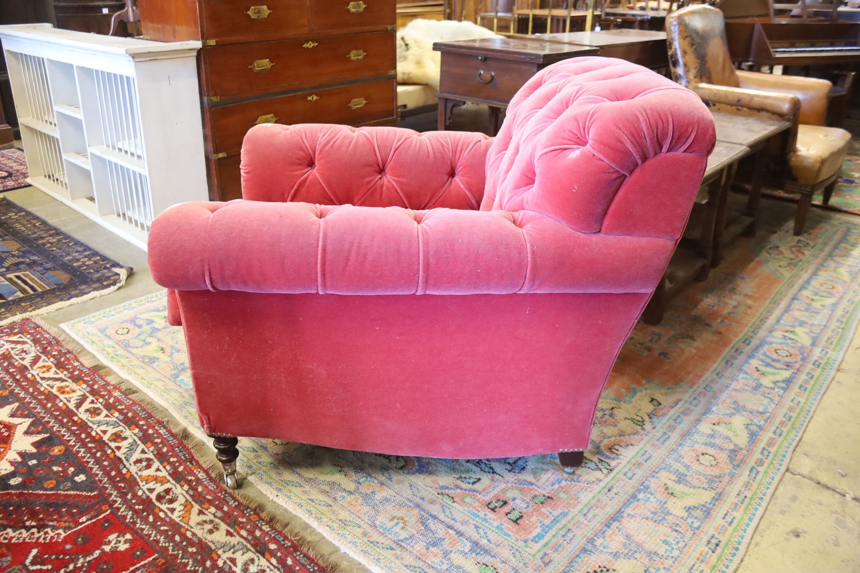 A George Smith armchair upholstered in buttoned pink fabric on turned legs, width 86cm, depth 95cm, height 80cm